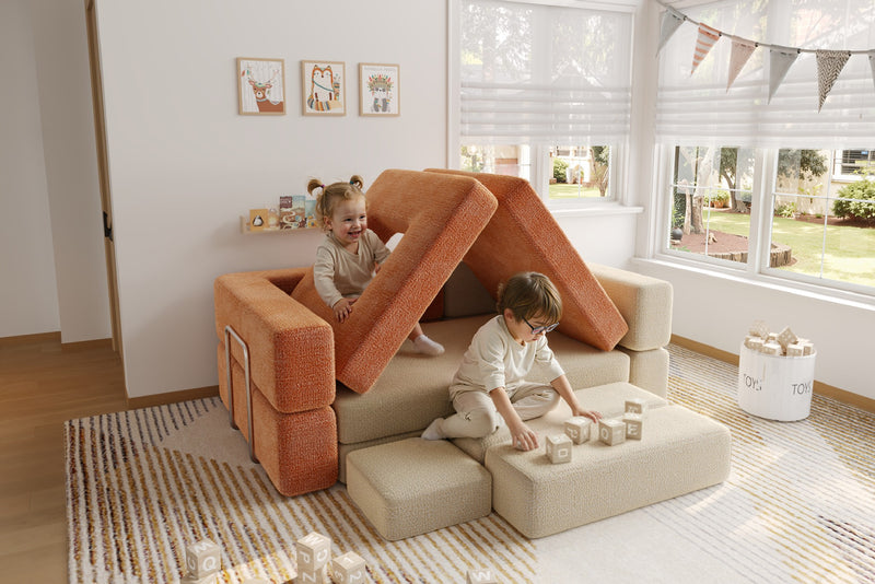 Children playing on modular kids play sofa in cream and orange colors – CushyLand by Acanva 9